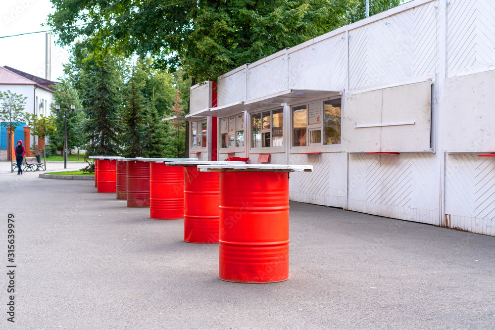 Creative table made of metal barrel or boogie. Unique outdoor cafe table in the park. Creative table made of metal barrel or boogie. Unique outdoor cafe table in the park.