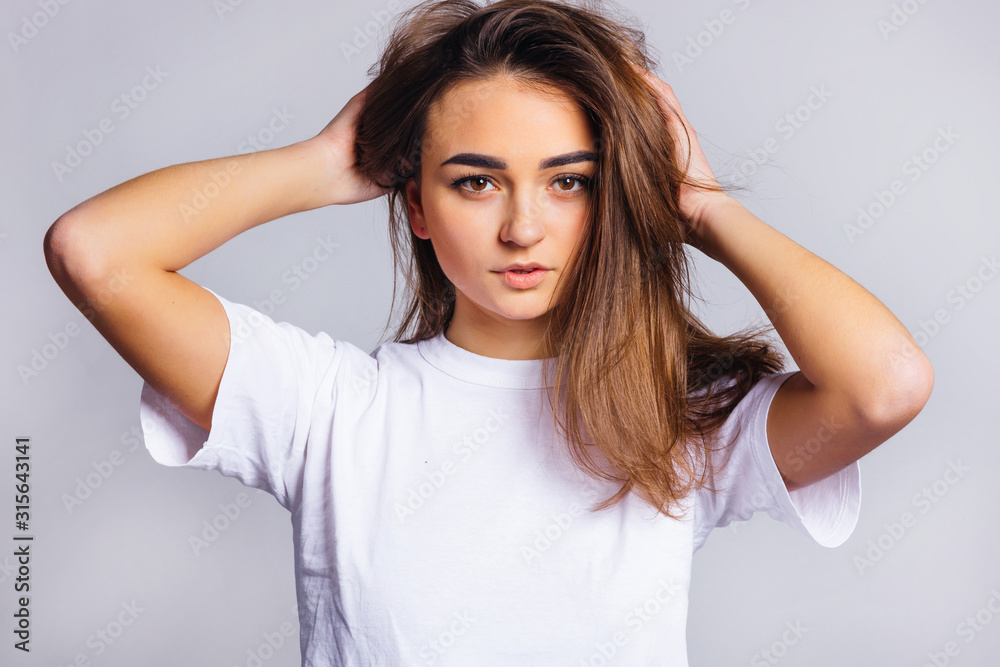 close-up face of a beautiful girl holding hands in her hair. sex close-up face of a beautiful girl holding hands in her hair. sex