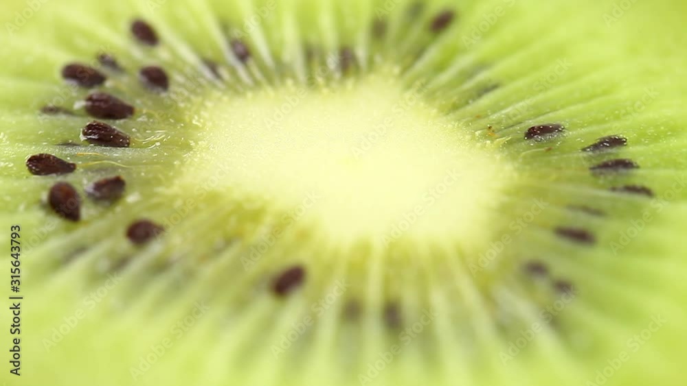 Kiwi rotates, cut tropical fresh fruit, middle green entrails. Macro close-up video footage. Kiwi rotates, cut tropical fresh fruit, middle green entrails. Macro close-up video footage.
