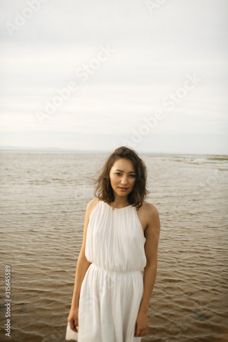 Woman in white dress on beach