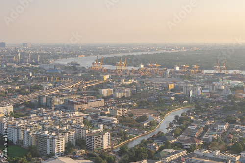 Bangkok / Thailand - 8 March 2019: Bird's eye view to show the beautiful sky and heavy traffic above the city view of Bangkok that is full of harmful PM 2.5 dust that is harmful to the body. © Pongvit