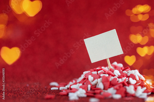 Empty blank in the heap red and white hearts on shiny redbokeh background. Valentine day concept. photo