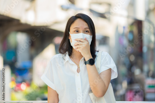 Woman wearing face mask protect filter against air pollution (PM2.5) or wear N95 mask. protect pollution, anti smog and viruses, Air pollution caused health problem. environmental pollution concept.