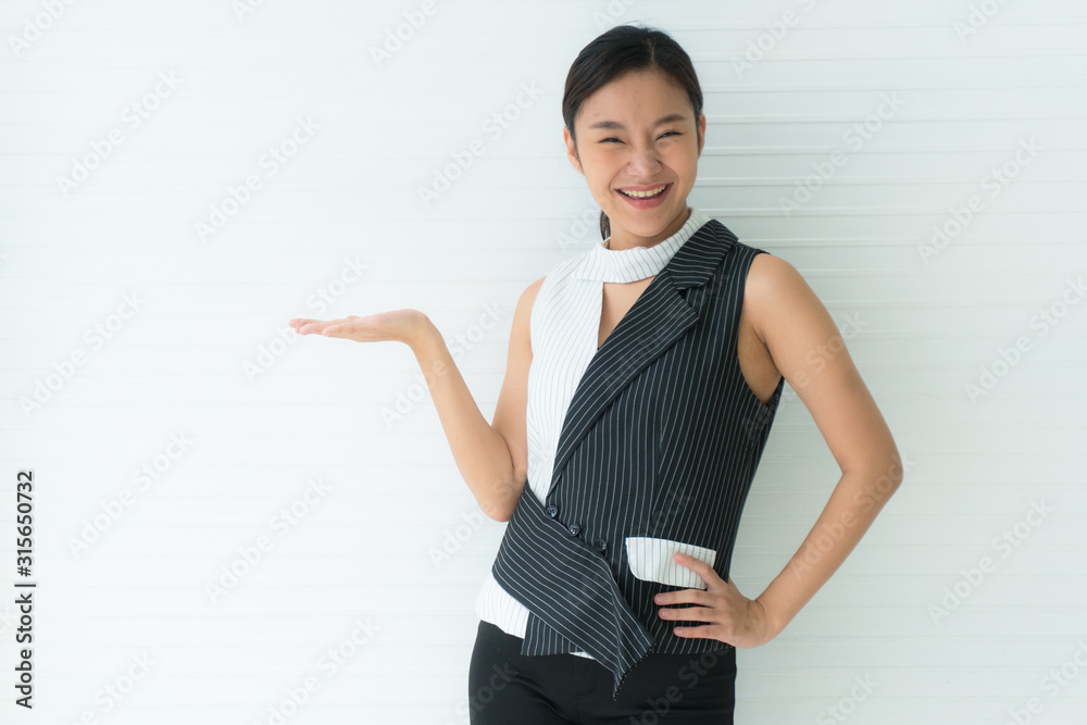 Portrait of Asian beautiful young woman with smile face standing and presenting with one hand Portrait of Asian beautiful young woman with smile face standing and presenting with one hand