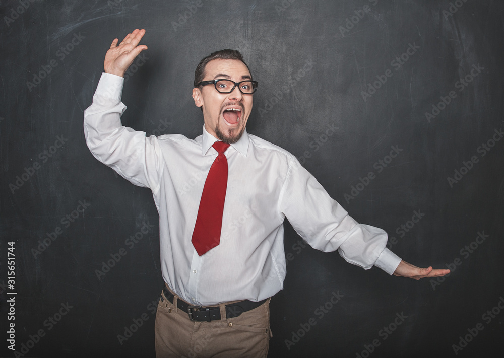 Funny handsome man dancing on chalkboard background Funny handsome man dancing on chalkboard background