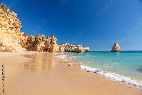 Fotografie, Obraz View on typical cliffy beach at Algarve coastline in Portugal in summer