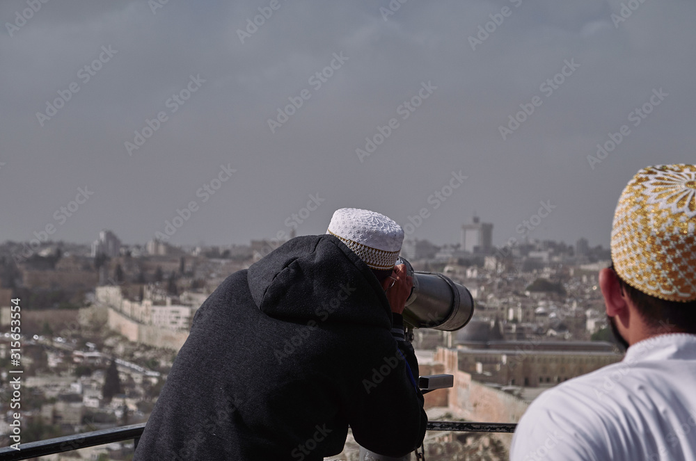 muslim tourists looking the city of Jerusalem with binoculars - ISRAEL.