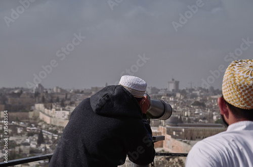 muslim tourists looking the city of Jerusalem with binoculars - ISRAEL.