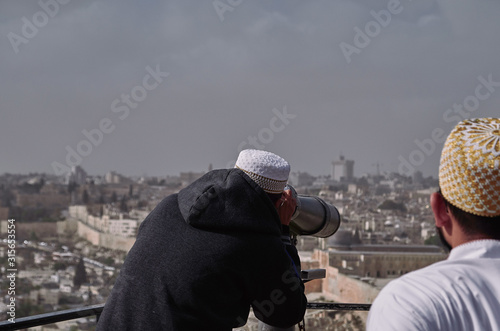 muslim tourists looking the city of Jerusalem with binoculars - ISRAEL. © Alessandro