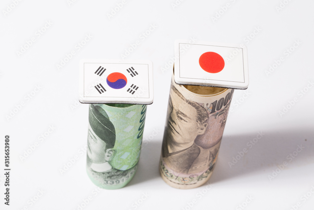 Obraz premium Korean won and Japanese Yen banknote money and flag