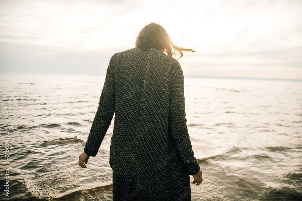 © Nikita - Woman portrait in coat on sea beach © Nikita - Woman portrait in coat on sea beach
