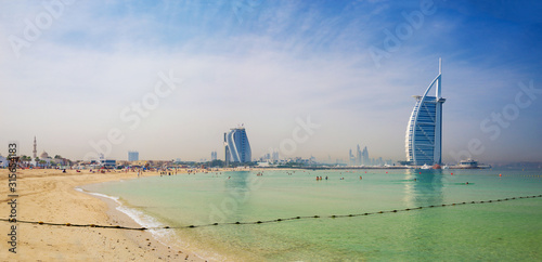 Fotografie DUBAI, UAE - MARCH 30, 2017: The evening skyline with the Burj al Arab and Jumeirah Beach Hotels and the open Jumeriah beach