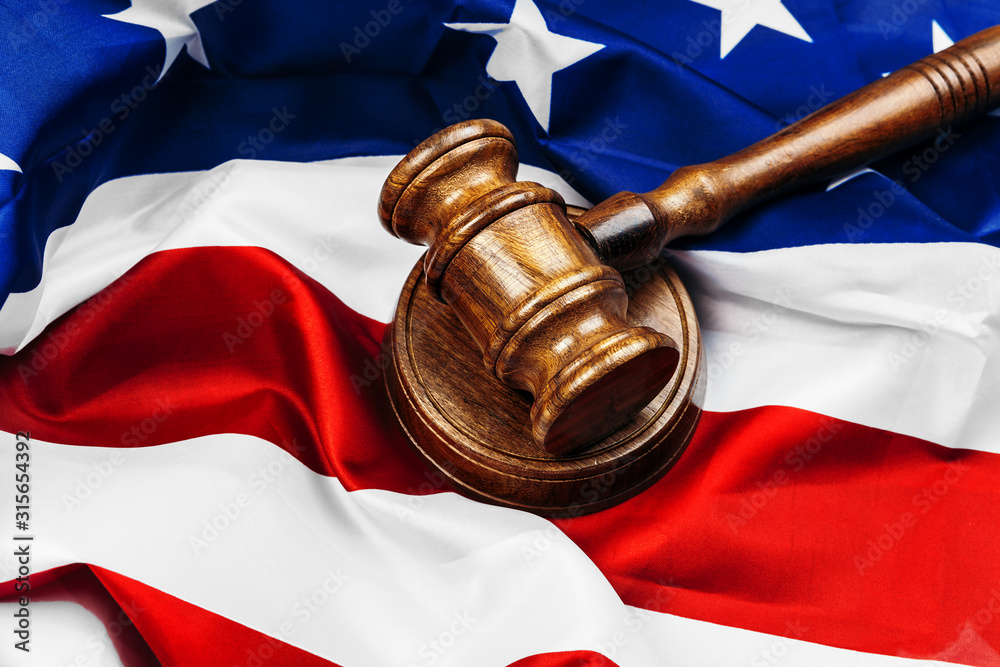 Gavel on wooden table with USA flag