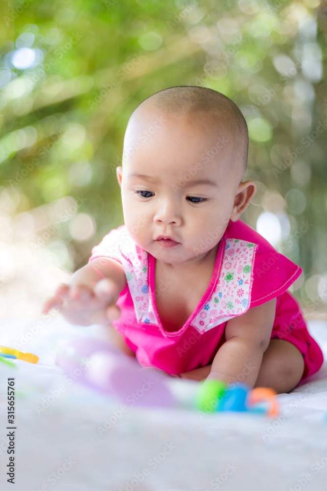 Cute little Asian baby sitting and play with happiness select focus shallow depth of field Cute little Asian baby sitting and play with happiness select focus shallow depth of field