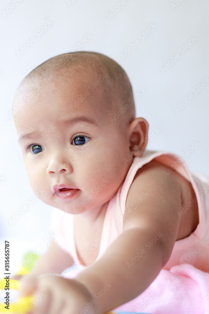 Cute little Asian baby sitting and play with happiness select focus shallow depth of field Cute little Asian baby sitting and play with happiness select focus shallow depth of field