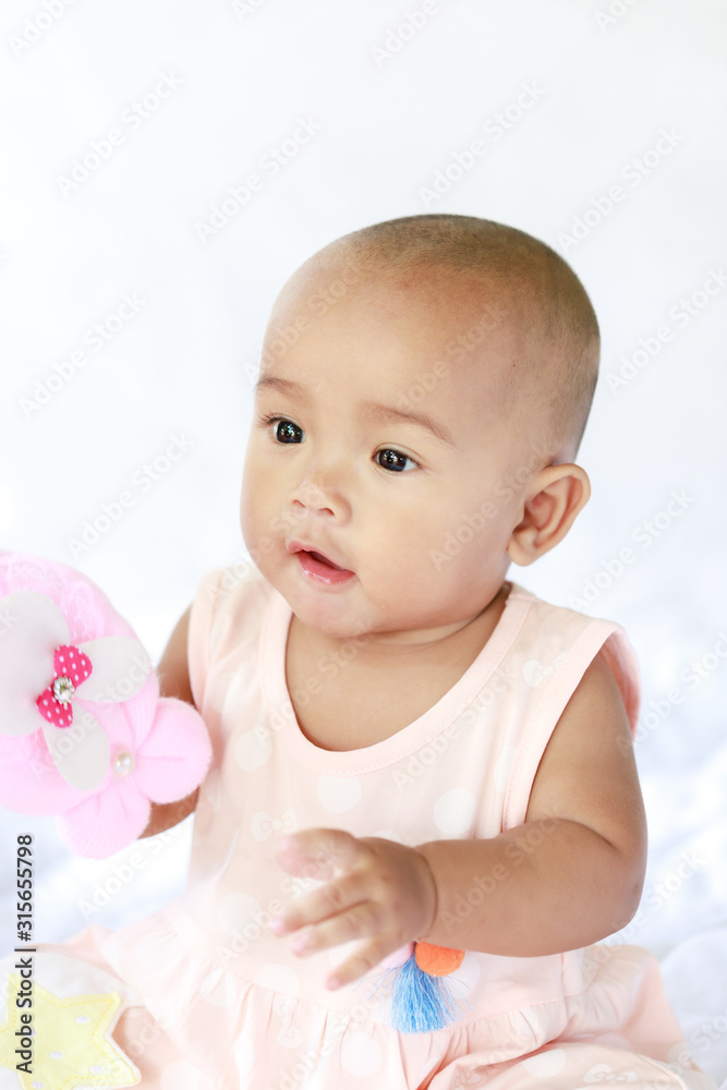 Cute little Asian baby sitting and play with happiness select focus shallow depth of field Cute little Asian baby sitting and play with happiness select focus shallow depth of field
