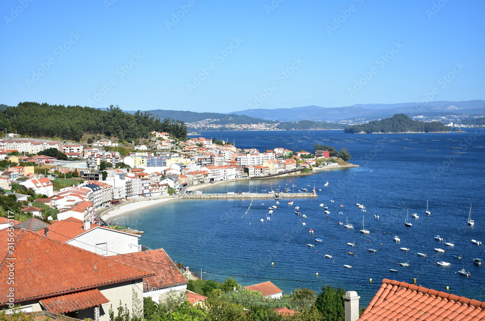 Bay and small fishing village with beach and boats. Raxo Harbour, Xiorto Beach, Poio Village. Rias Baixas, Pontevedra, Galicia, Spain. 