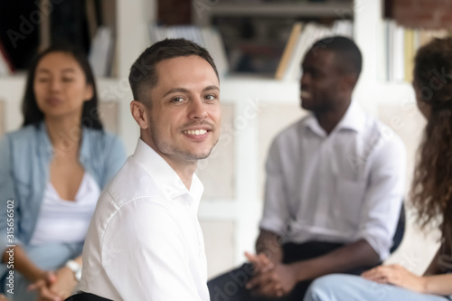 Relieved Caucasian man posing at group therapy session photo