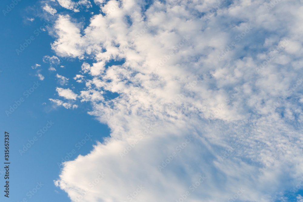 Clear weather with cirrus and cumulus clouds on a bright clear blue sky. Positive landscape Clear weather with cirrus and cumulus clouds on a bright clear blue sky. Positive landscape