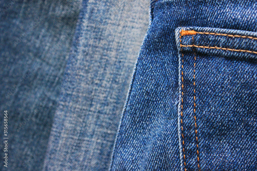 Blue jeans backside pocket design close up detail. Jeans wallpaper, casual  denim fabric of classic trousers, clothing element with seams and stitches  Stock Photo | Adobe Stock