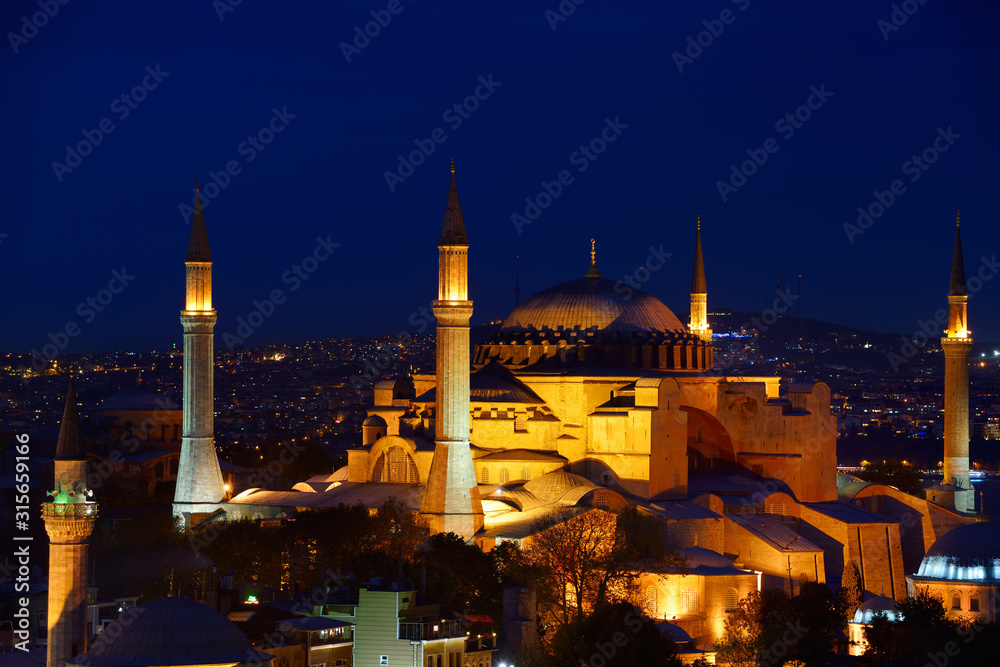 Fototapeta premium Night lights on Hagia Sophia and Firuz Aga Mosque at twilight in Istanbul Turkey