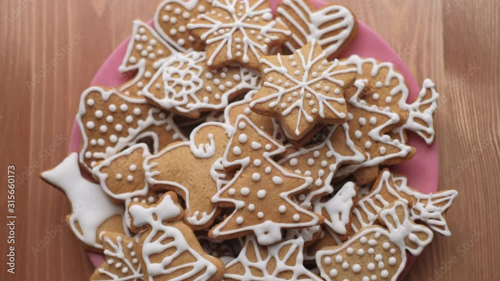 Detail of hands taking traditional gingerbread Christmas cookies from a plate. Dolly shot. Shallow depth of field. Czech Republic Detail of hands taking traditional gingerbread Christmas cookies from a plate. Dolly shot. Shallow depth of field. Czech Republic