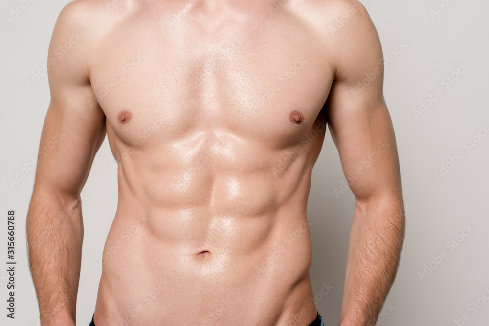 cropped view of sexy man with muscular torso isolated on grey