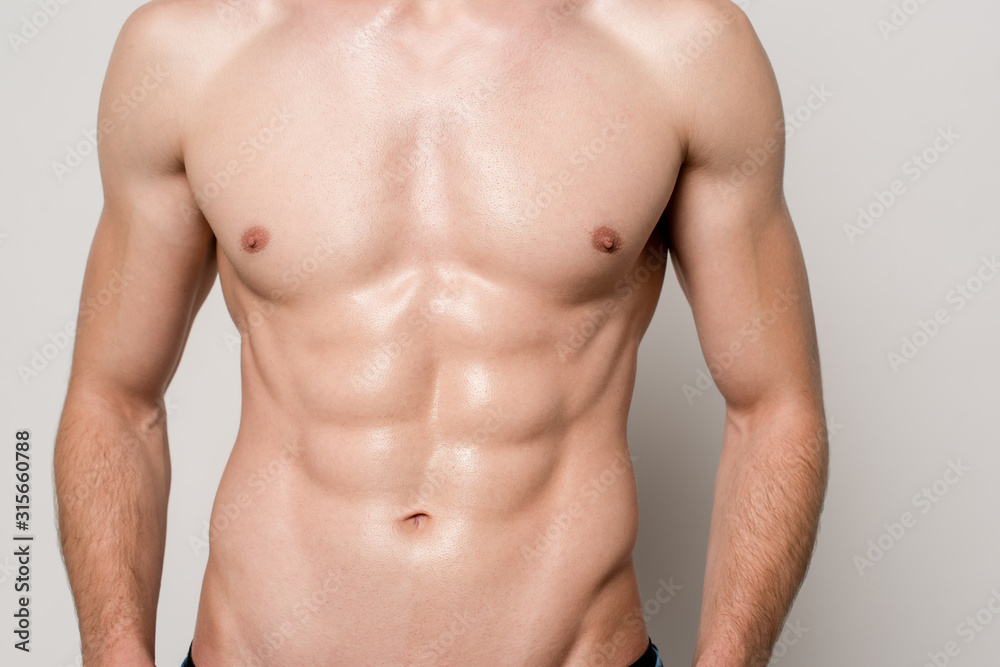 cropped view of sexy man with muscular torso isolated on grey cropped view of sexy man with muscular torso isolated on grey