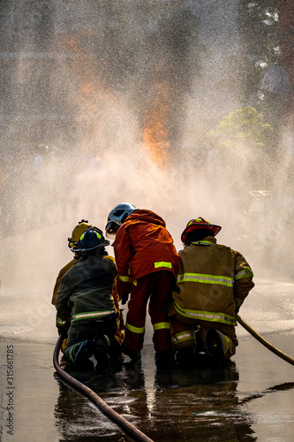 The Firefighters demonstrating fire fighting.