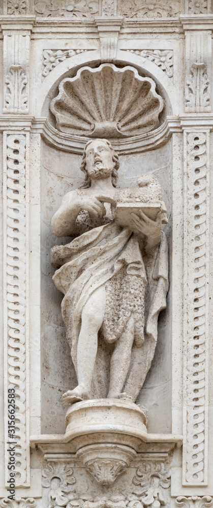 ACIREALE, ITALY - APRIL 11, 2018: The statue of St. John the Baptist on the facade of Basilica Collegiata di San Sebastiano designed by Angelo Bellofiore 18. cent.