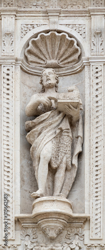 ACIREALE, ITALY - APRIL 11, 2018: The statue of St. John the Baptist on the facade of Basilica Collegiata di San Sebastiano designed by Angelo Bellofiore 18. cent. photo