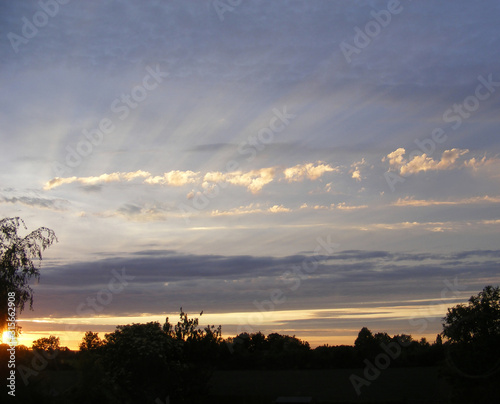 sun rays over clouds in the evening
