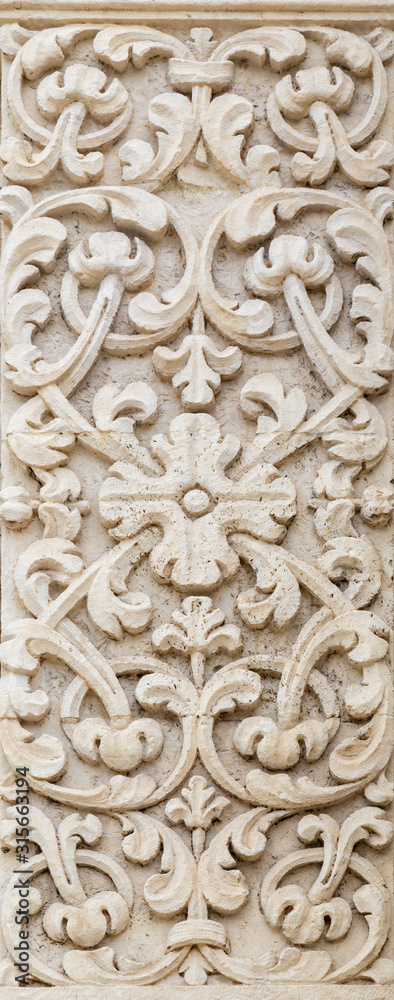 ACIREALE, ITALY - APRIL 11, 2018: The floral relief on the facade of church  Basilica Collegiata di San Sebastiano.
