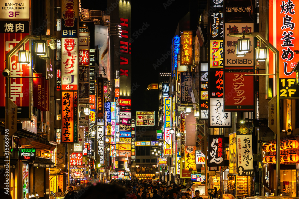 TOKYO, JAPAN - December, 2019: Crowds pass through Kabukicho in the  Shinjuku district. The area is an entertainment and red-light district.  Stock Photo | Adobe Stock