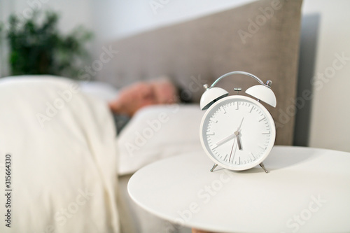 A Senior woman having sleep disorder, lying in bed