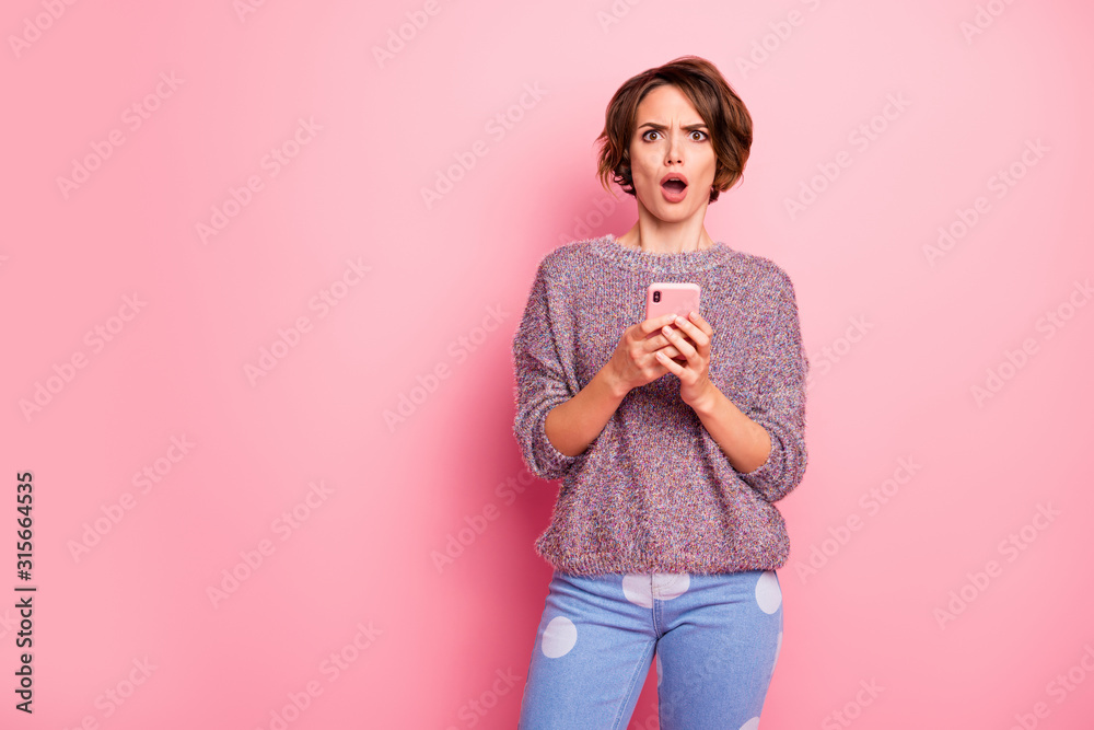 Portrait of her she nice-looking attractive lovely pretty charming worried outraged brown-haired girl using cell reading fake bad news isolated over pink pastel color background Portrait of her she nice-looking attractive lovely pretty charming worried outraged brown-haired girl using cell reading fake bad news isolated over pink pastel color background