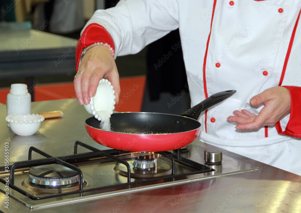 Chef, white sugar poured into a pan to fried. Chef, white sugar poured into a pan to fried.
