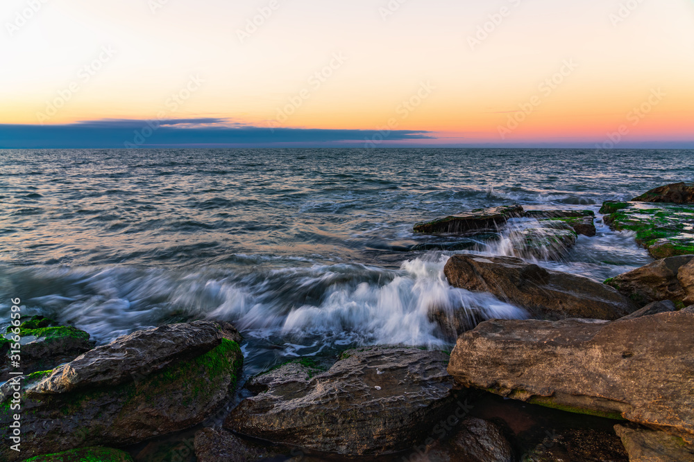 Waves crashing on the rocky seashore