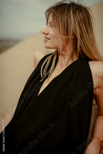 Woman in black dress portrait in desert 