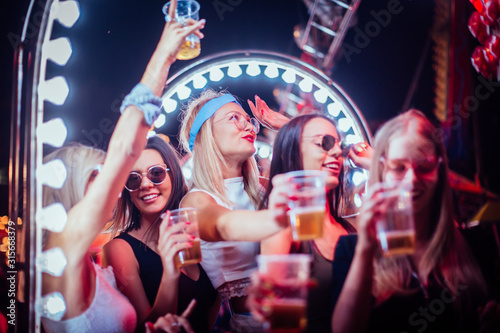 Group of friends toasting and having fun in the club