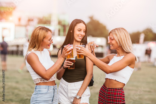 Girls cheering with beer at the music festival