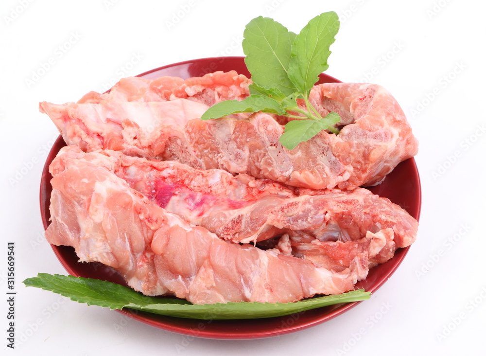 Raw Pork Ribs in red plate On White Background Raw Pork Ribs in red plate On White Background