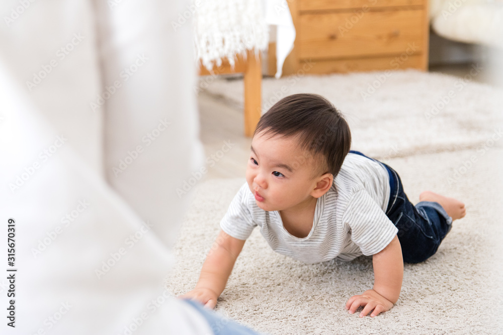 Asian baby crawl towards their parents. His face is smiling. Asian baby crawl towards their parents. His face is smiling.
