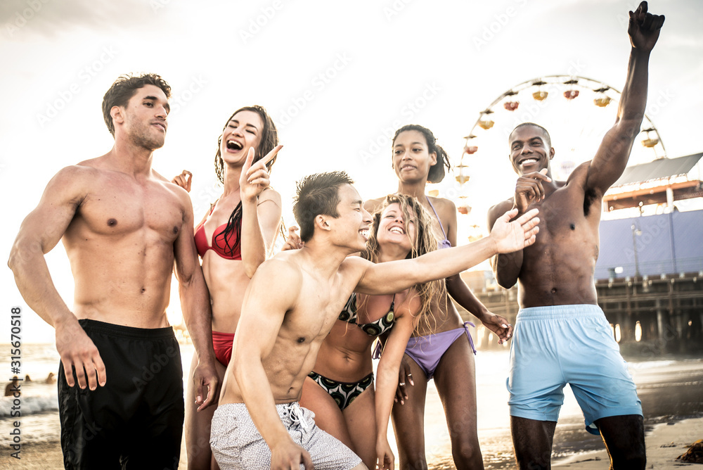 Group of friends making big party and games on the beach Group of friends making big party and games on the beach