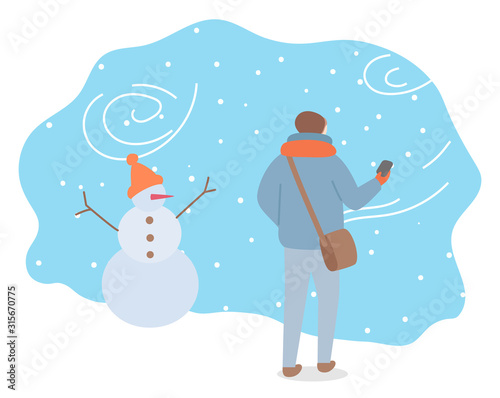 Winter snowstorm and bag weather conditions outdoors. Man wearing warm clothes passing snowman with hat. Landscape in wintertime, snowflakes and frost outside. Seasonal temperature vector in flat