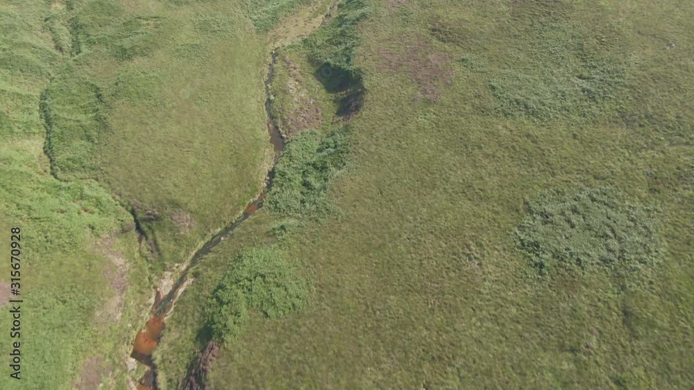 Aerial drone stream leading to reservoir through moors, Yorkshire Aerial drone stream leading to reservoir through moors, Yorkshire
