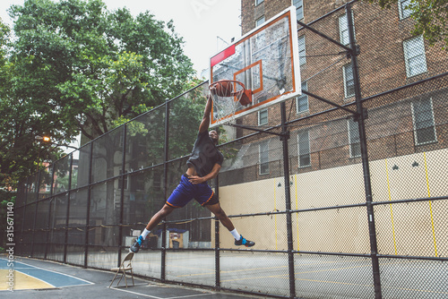 Basketball player making a huge slam dunk