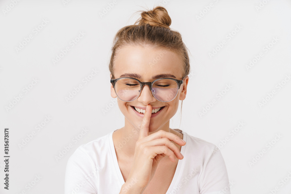 Photo of cheerful caucasian woman making silence gesture Photo of cheerful caucasian woman making silence gesture