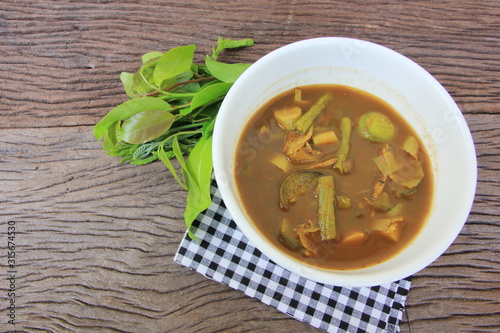Tai Pla Curry, local food of the southern region.Thailand,Fish organs sour soup on the brown wooden.