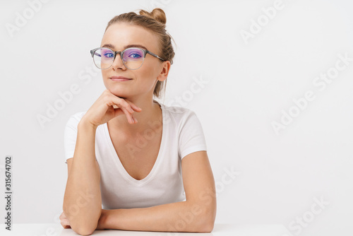 Photo of beautiful pleased woman posing and looking at camera